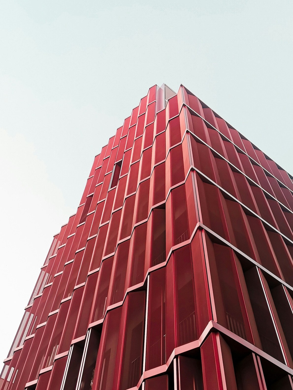 Red facade of a residential building at Browary Warszawskie in Warsaw