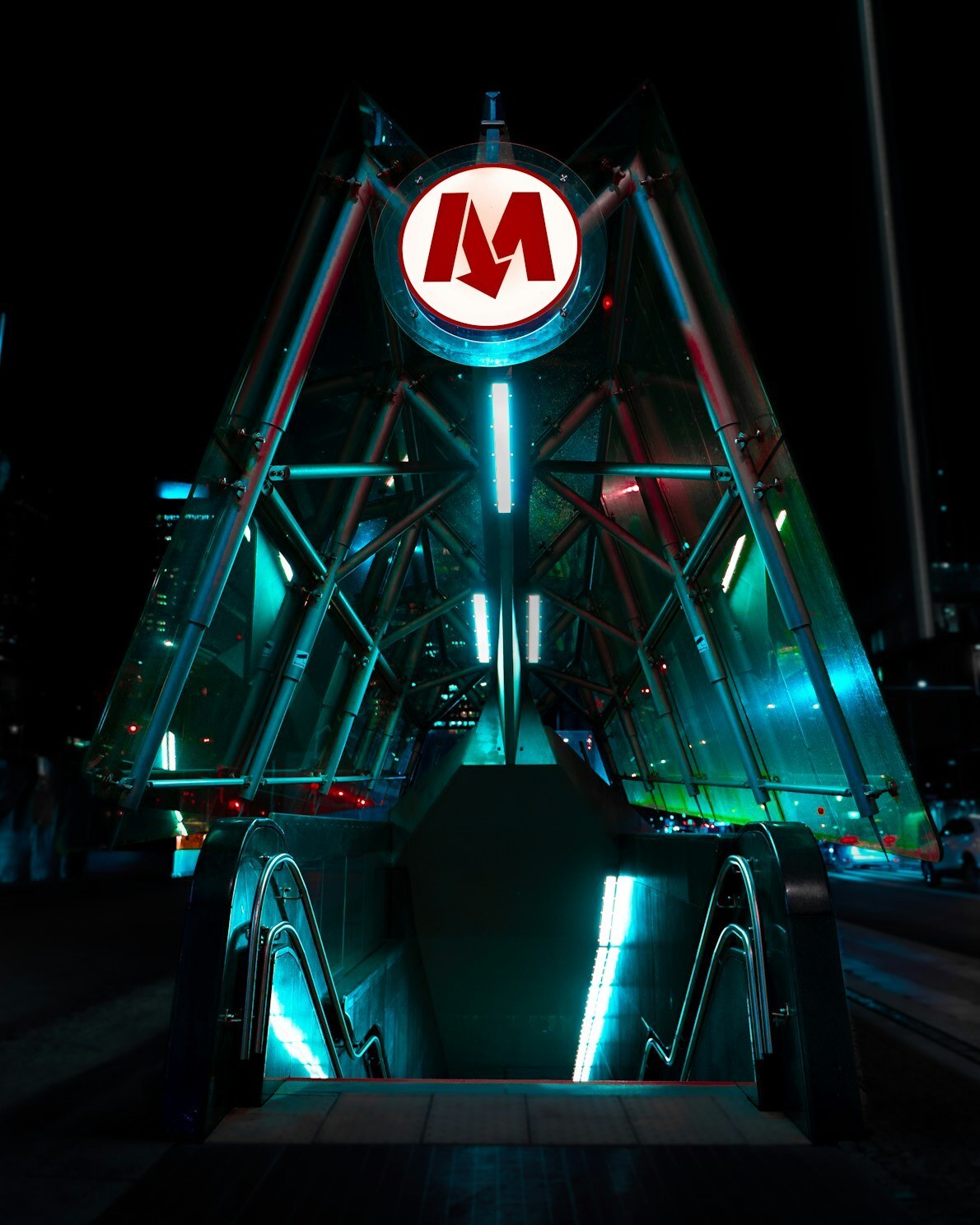 Illuminated entrance to Świętokrzyska metro station in Warsaw at night