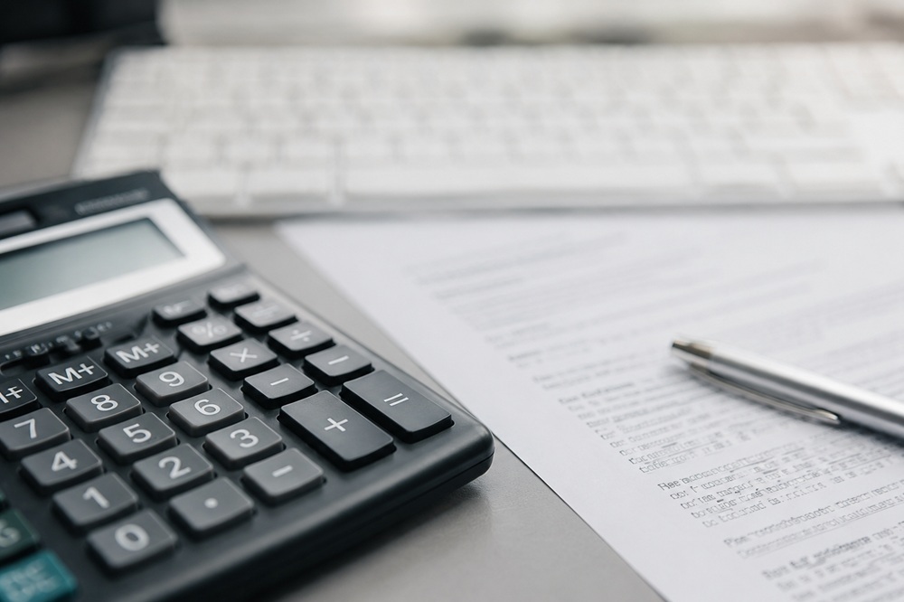 Calculator and purchase documents used to prepare a negotiation offer for a Warsaw apartment