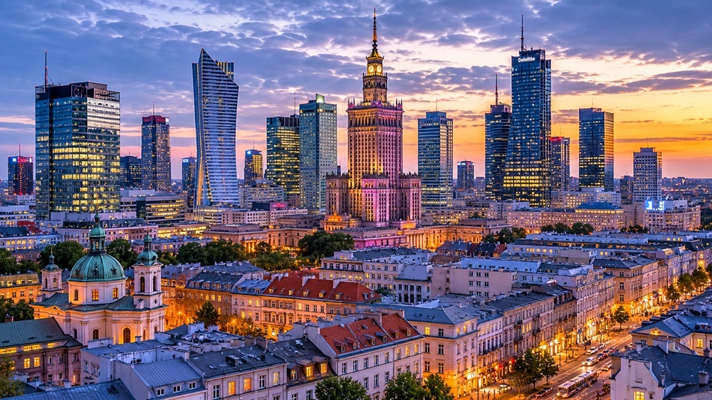 Warsaw skyline at sunset — historic tenements and modern towers across the property search coverage area