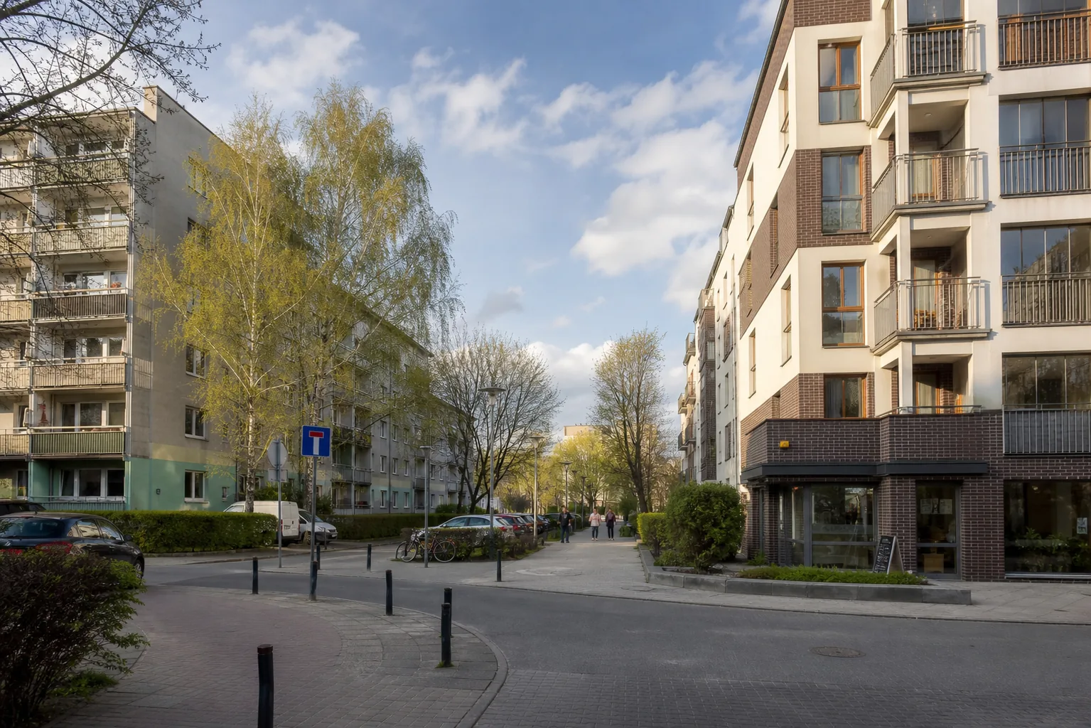 Older and contemporary apartment buildings sharing one Bemowo residential street