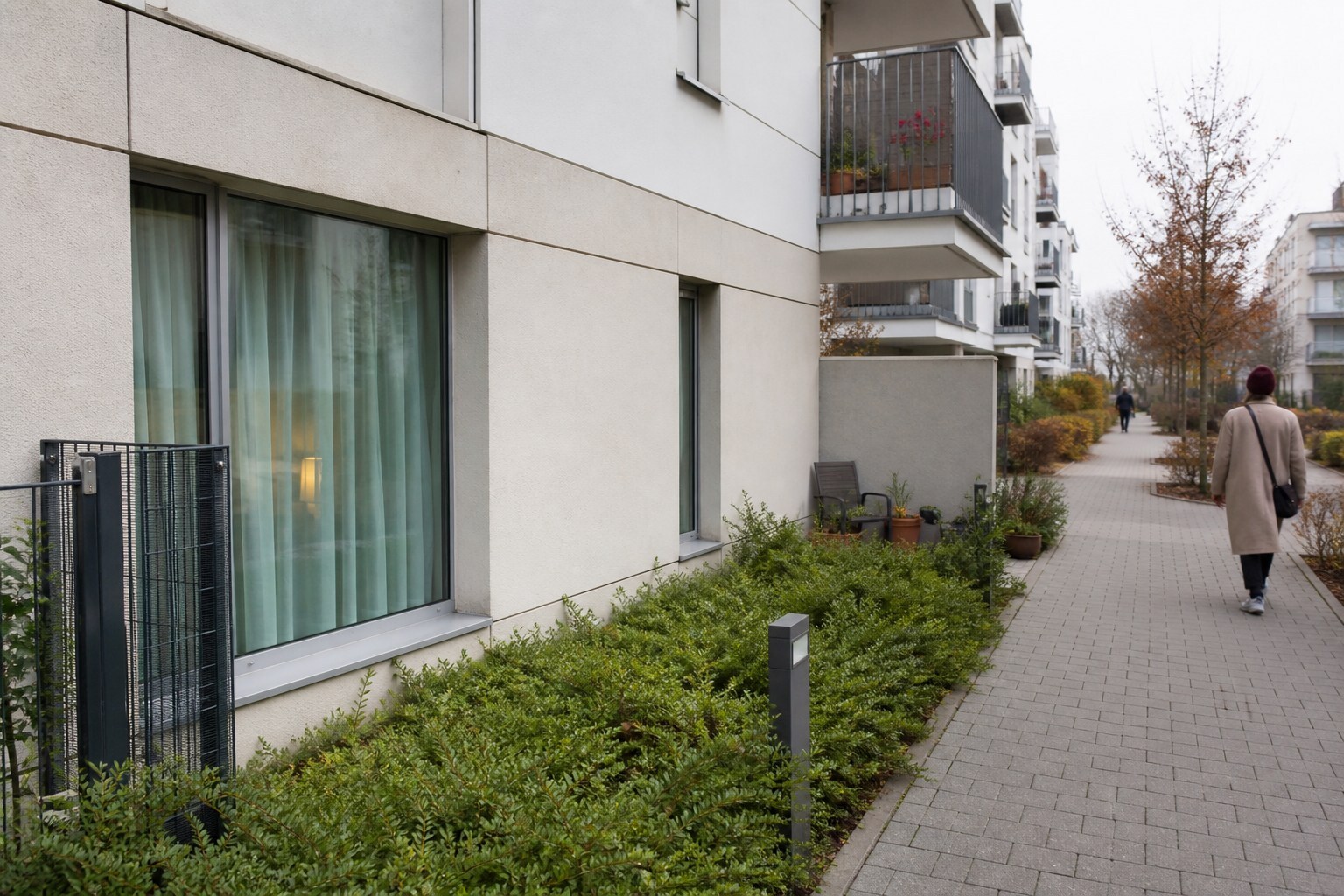 Street-level view towards the window of a ground-floor Warsaw apartment