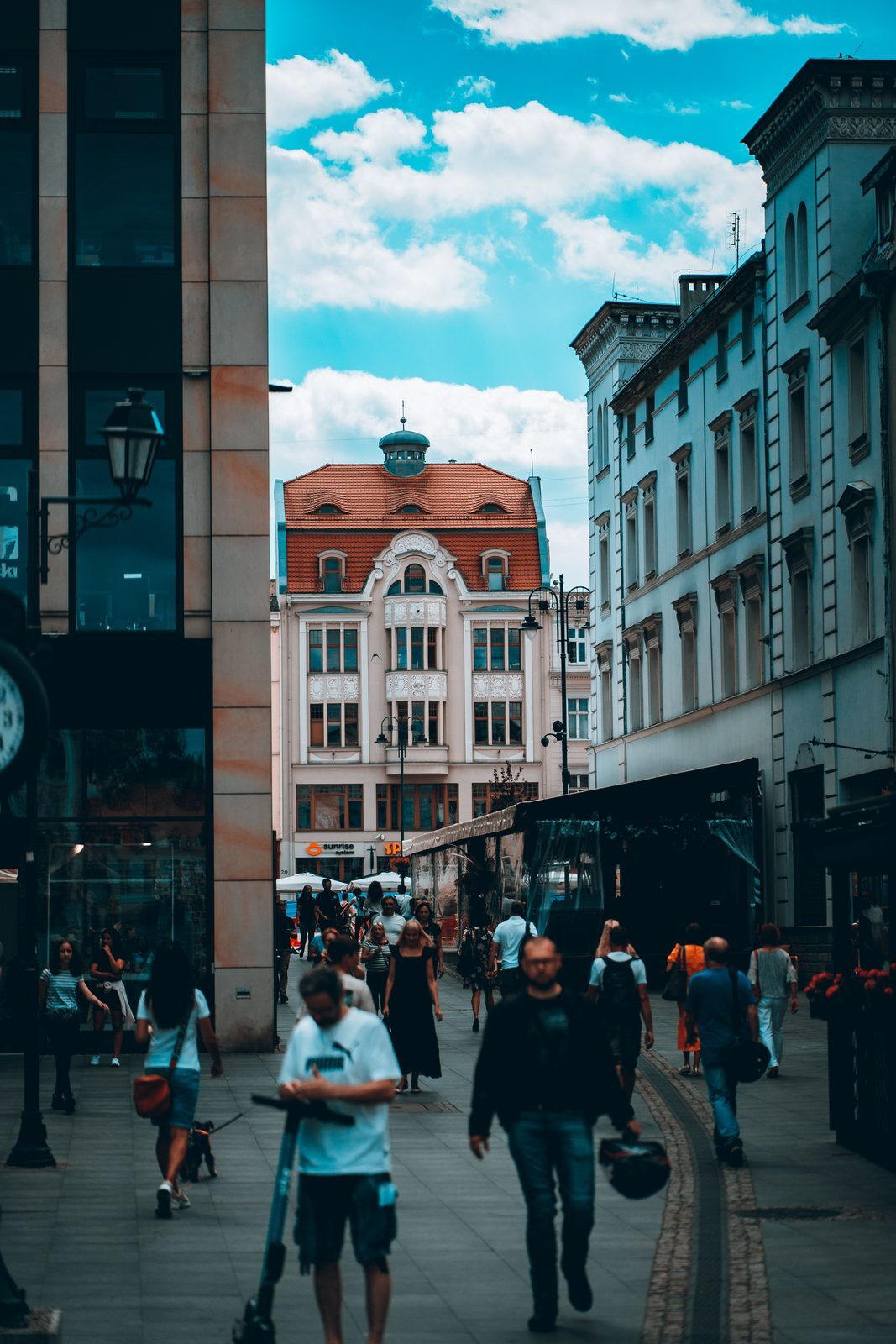 Historic and modern Warsaw street life for expats deciding whether to rent or buy